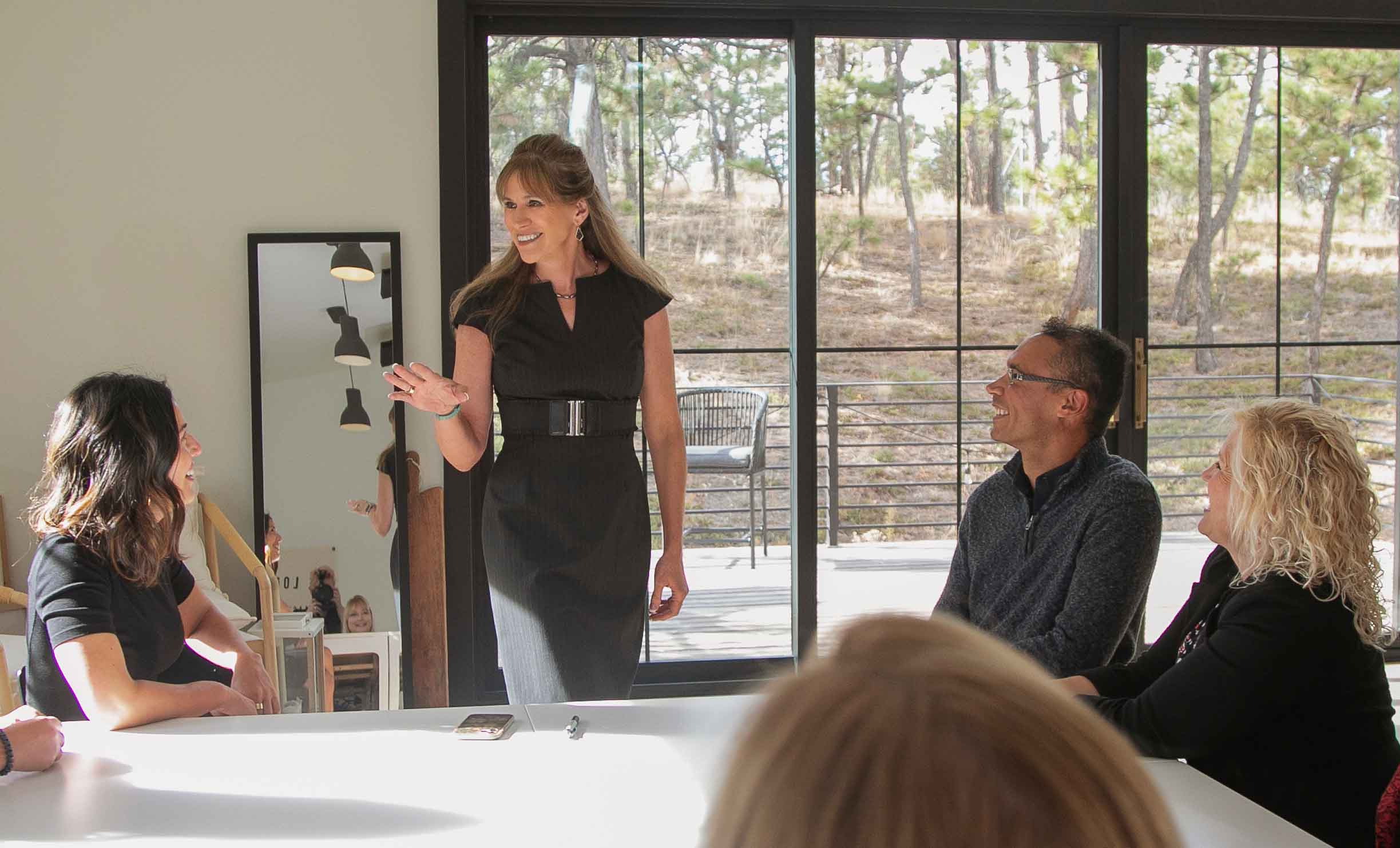 Kristin Paris Teaches a Group of People Seated at a Table